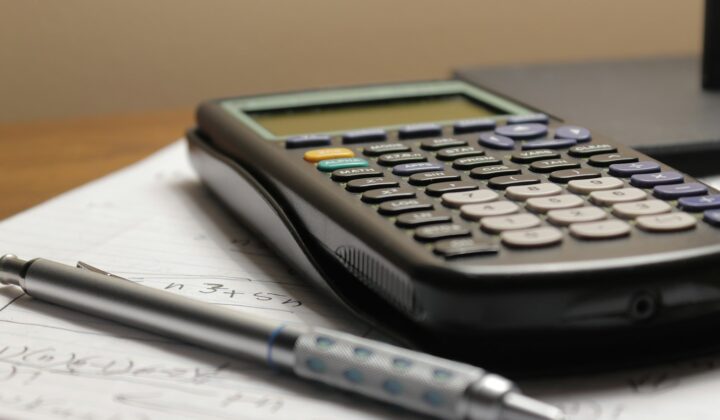 Calculator and pen on paperwork