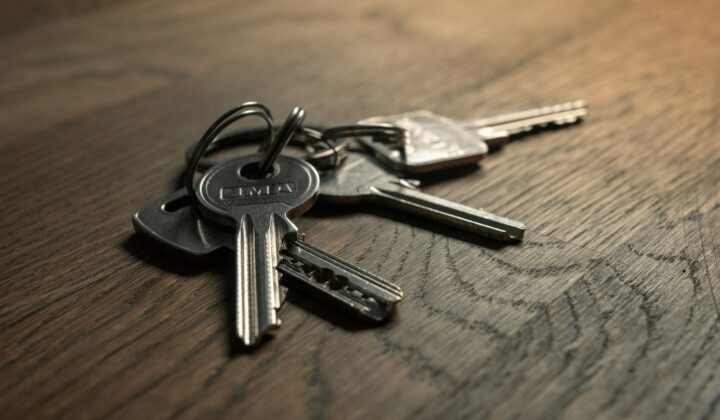 A bunch of keys on a wooden table