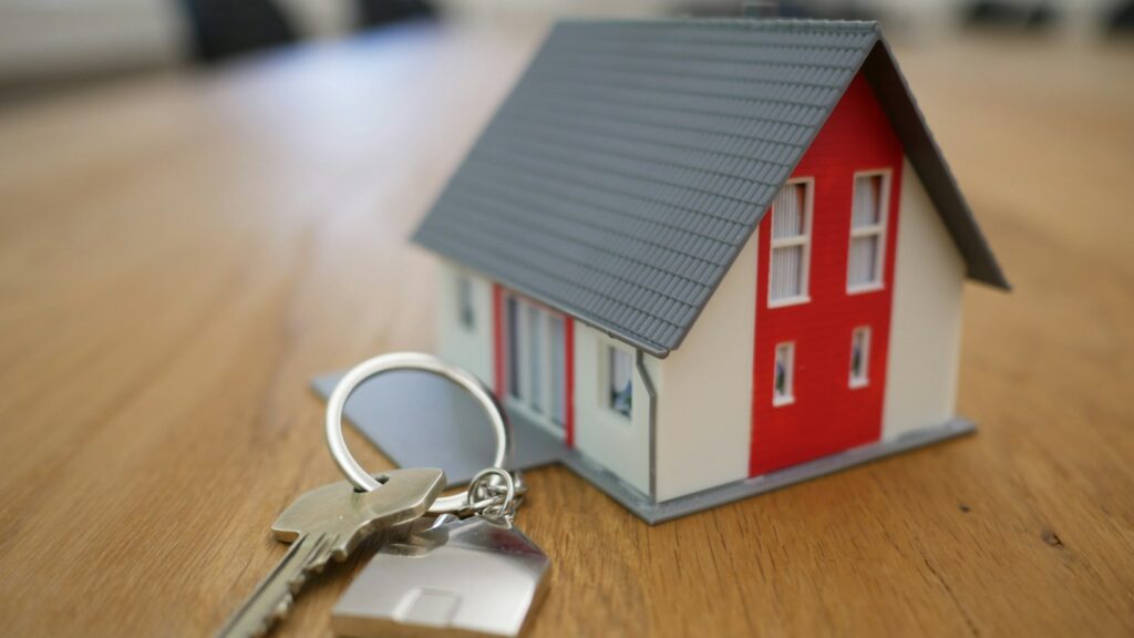 Miniature white and red house on a table