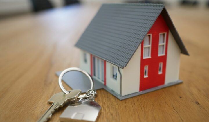 Miniature white and red house on a table
